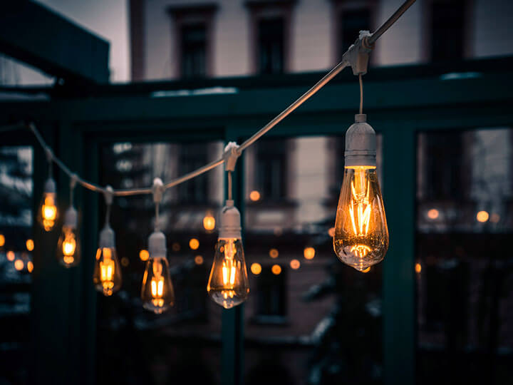 Stylish Edison light bulbs hanging from a cord in a cafe