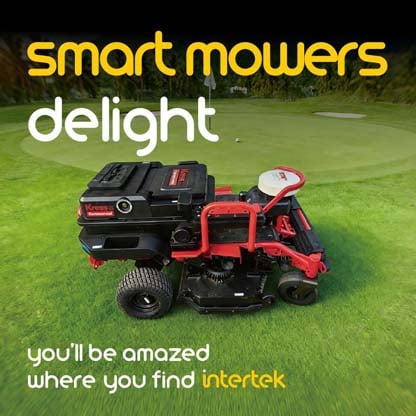 A riding lawn mower parked at a golfing green